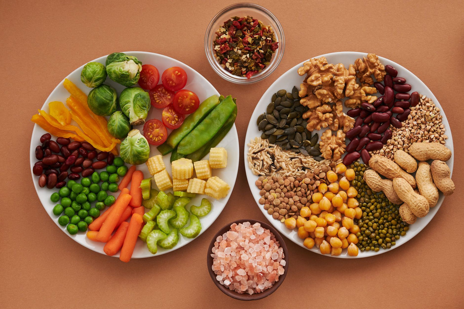 Vibrant display of assorted vegetables, legumes, nuts, and seeds on plates, perfect for healthy eating images
