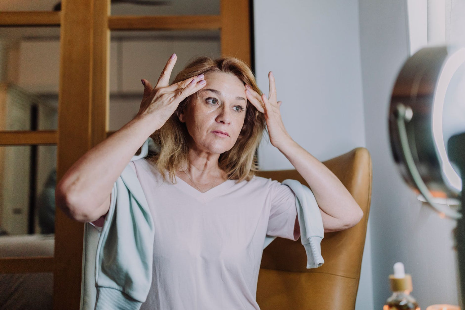 A mature woman practicing her skincare routine, emphasizing self-care and wellness
