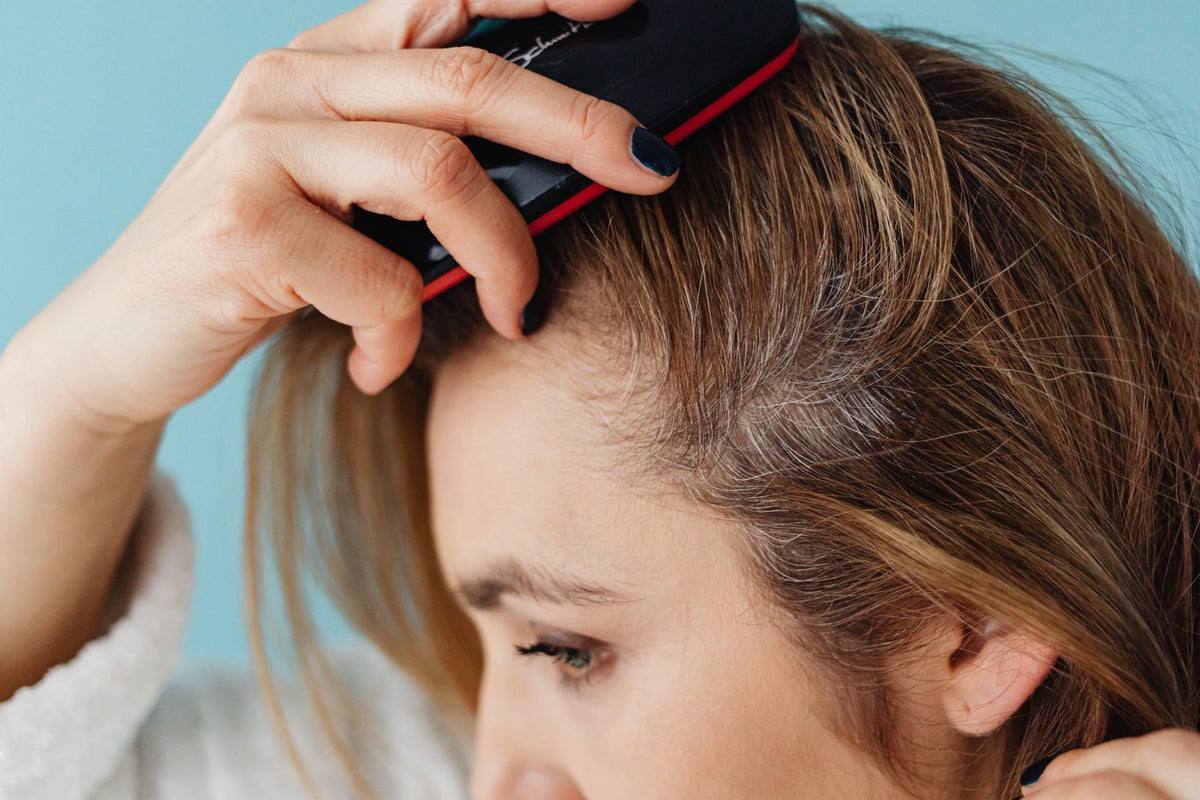 A woman brushing her hair showing hair texture and care