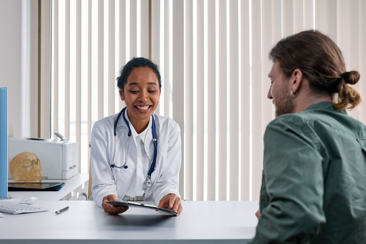 A doctor and patient engaging in a positive consultation in a bright clinic setting