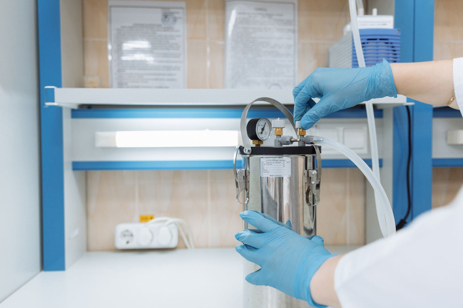 Scientist adjusting laboratory equipment with precision in a modern lab setting, wearing blue gloves
