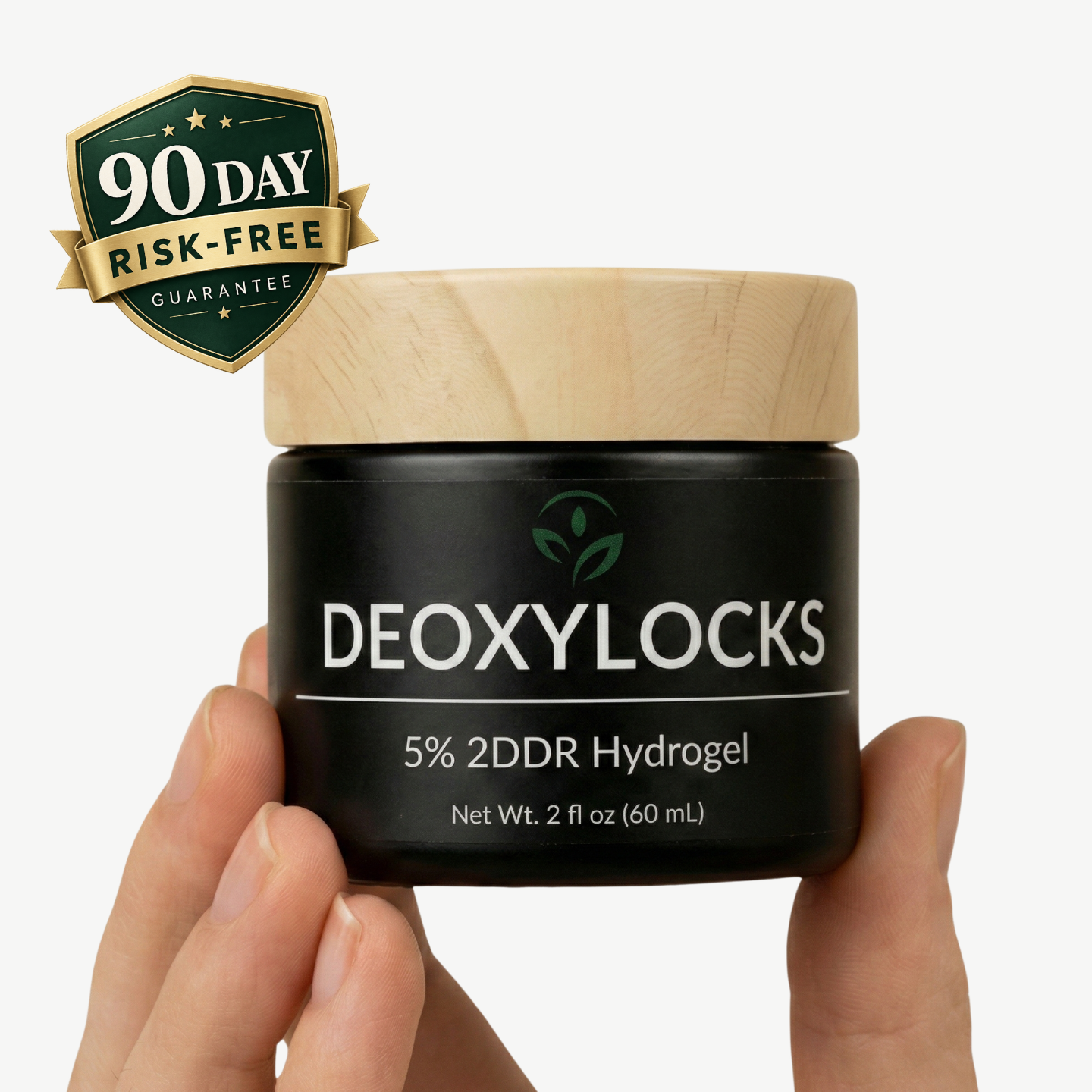 A hand holding a black jar of DEoxyLocks 5% 2DDR Hydrogel with a light wood-grain lid, featuring a green &