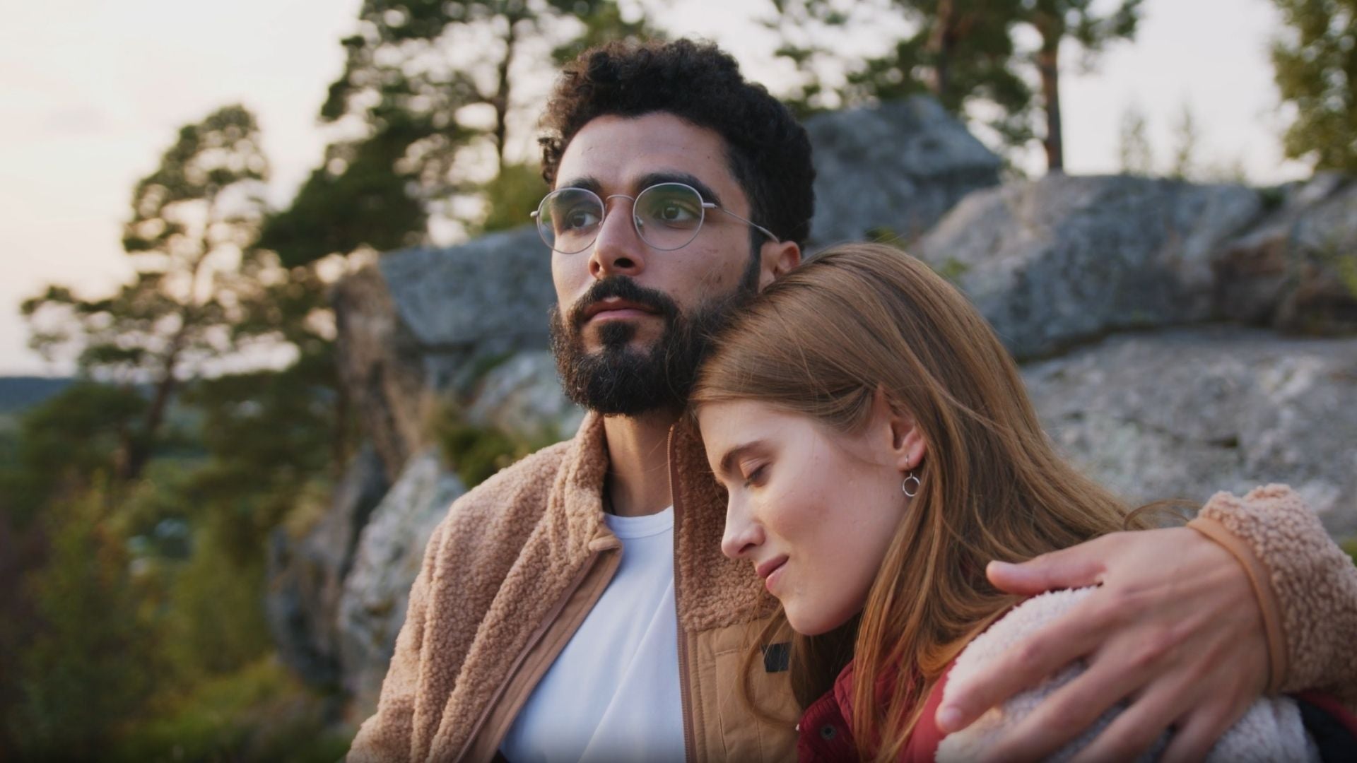 man on rock with women