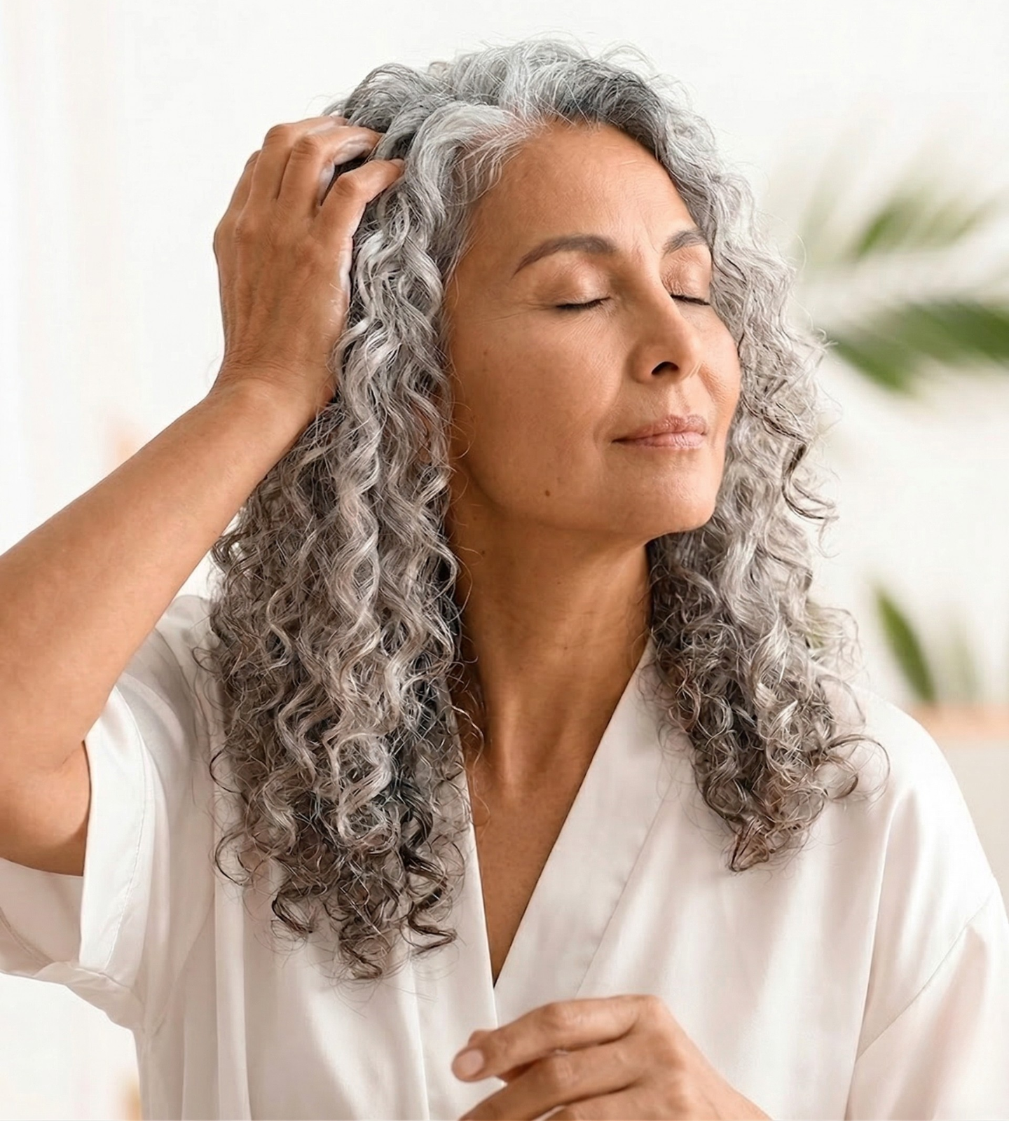 Woman touching her scalp showing concern for menopause hair thinning and hair regrowth treatment