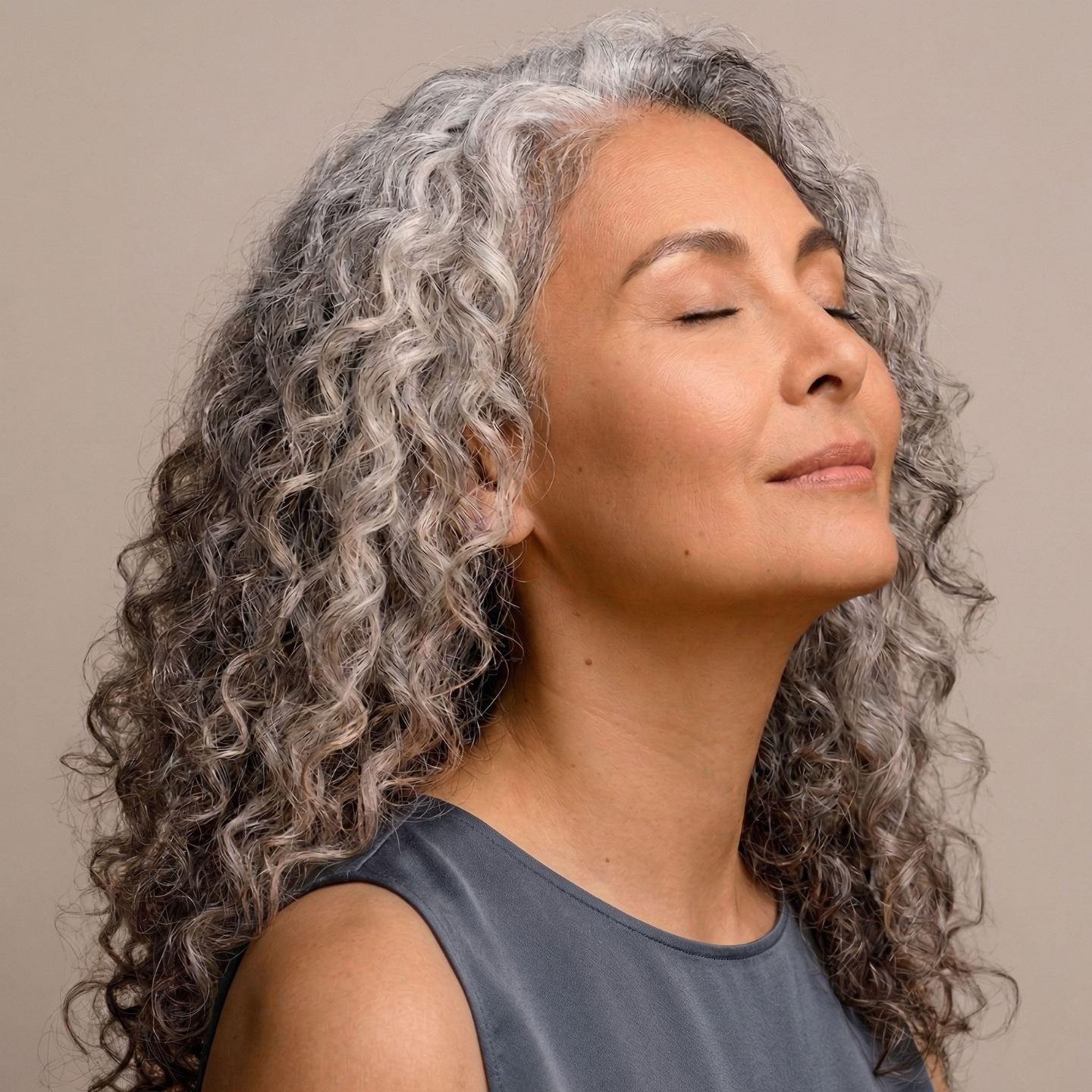 Woman with gray hair showing signs of menopause hair thinning and hair regrowth treatment